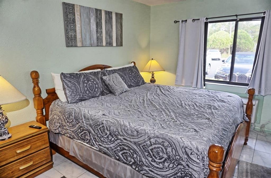 20921 Haulover Cove Road, Unit F5 Lutz, FL 33558 - Photo 12 of 34 a bedroom with a bed and a window