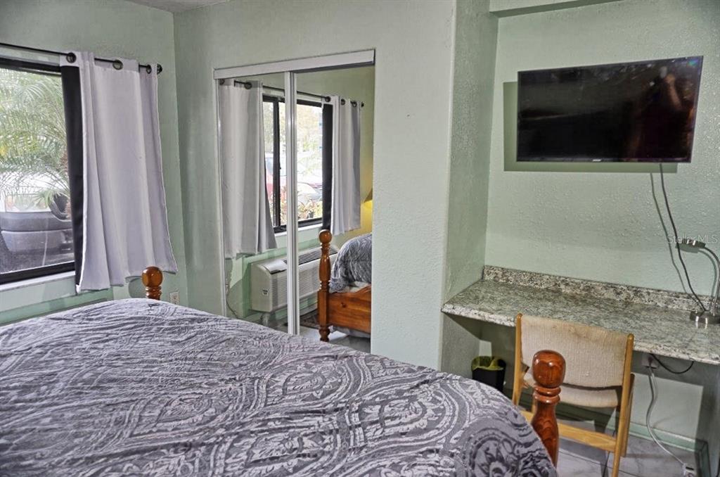 20921 Haulover Cove Road, Unit F5 Lutz, FL 33558 - Photo 15 of 34 a bedroom with a bed and a flat screen tv