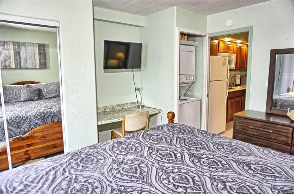 20921 Haulover Cove Road, Unit F5 Lutz, FL 33558 - Photo 18 of 34 a bedroom with a bed and wooden floor