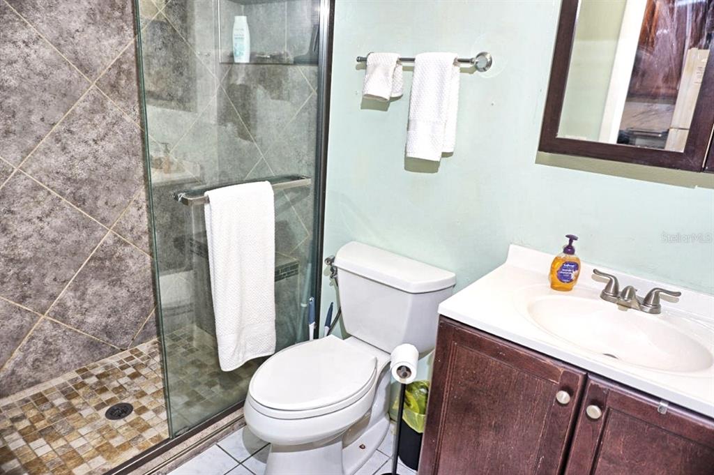 20921 Haulover Cove Road, Unit F5 Lutz, FL 33558 - Photo 22 of 34 a white toilet sitting next to a bathroom sink