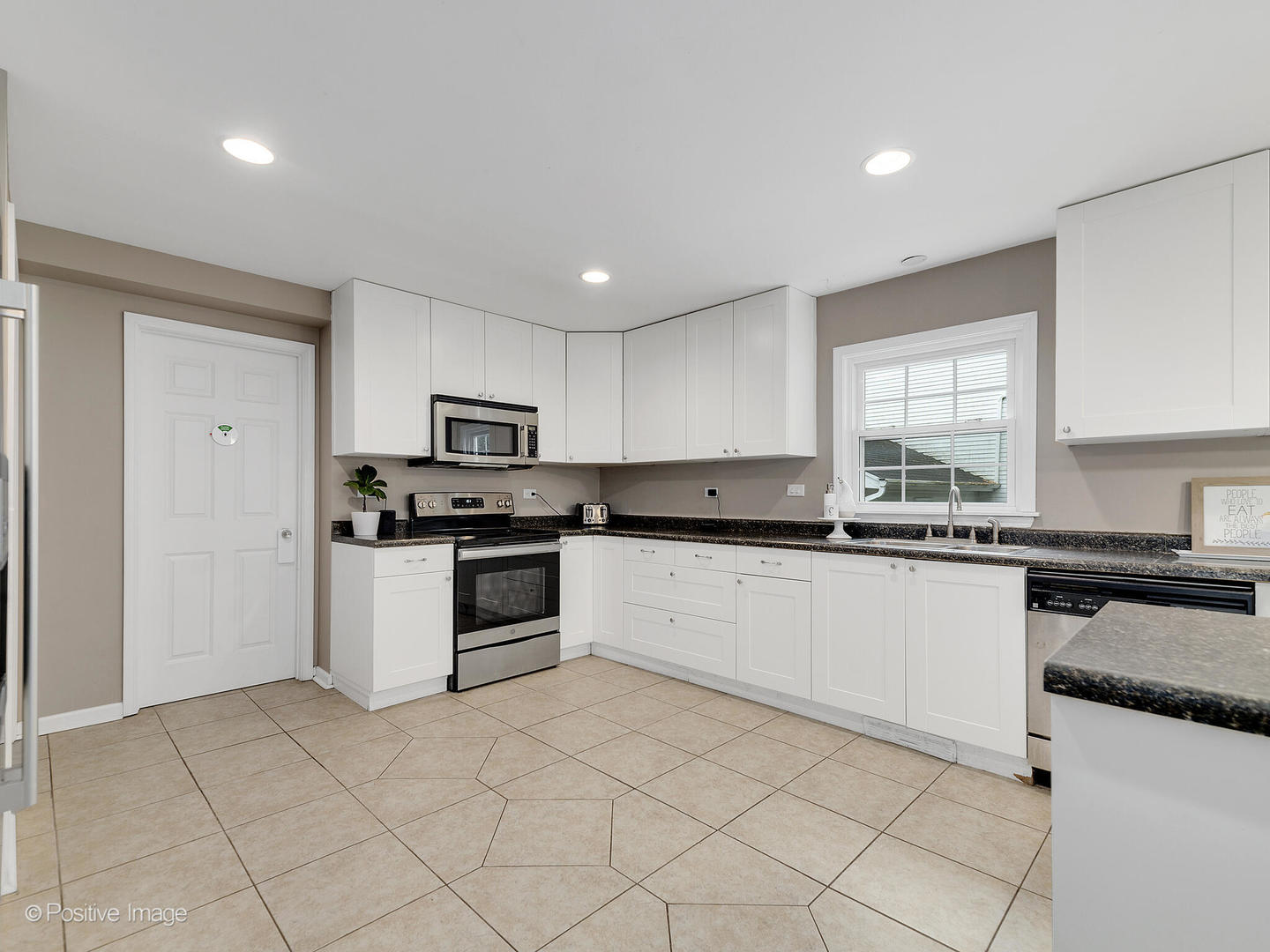 800 West Roosevelt Road Wheaton, IL 60187 - Photo 12 of 28 a kitchen with granite countertop white cabinets white appliances a sink and a window
