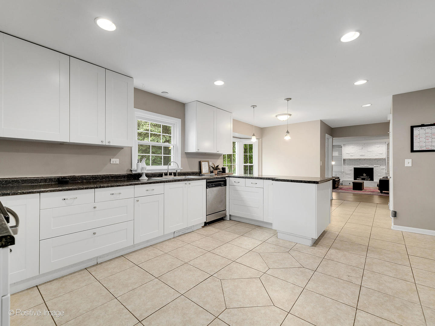 800 West Roosevelt Road Wheaton, IL 60187 - Photo 13 of 28 a large white kitchen with white cabinets