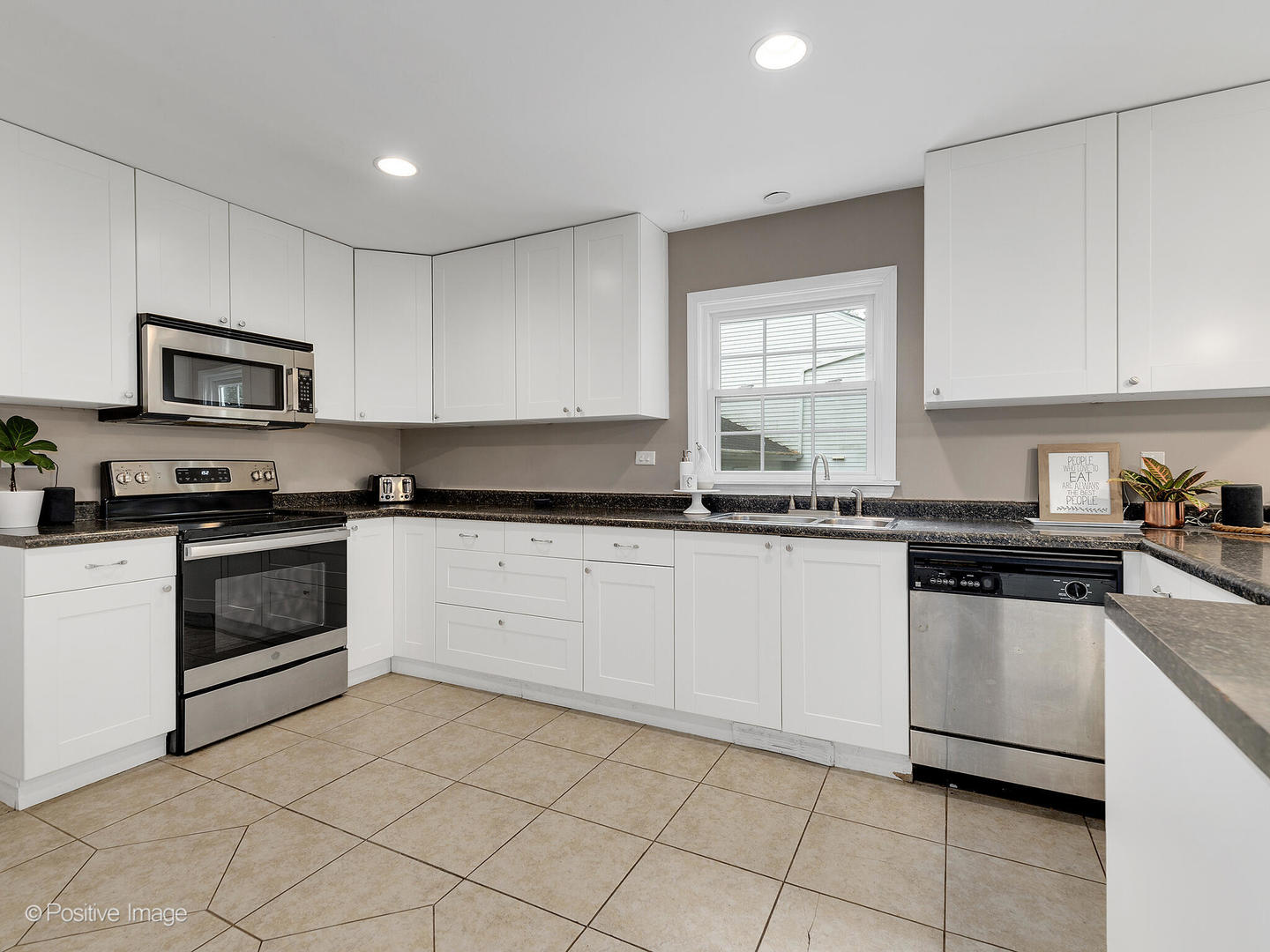 800 West Roosevelt Road Wheaton, IL 60187 - Photo 14 of 28 a kitchen with granite countertop white cabinets and appliances