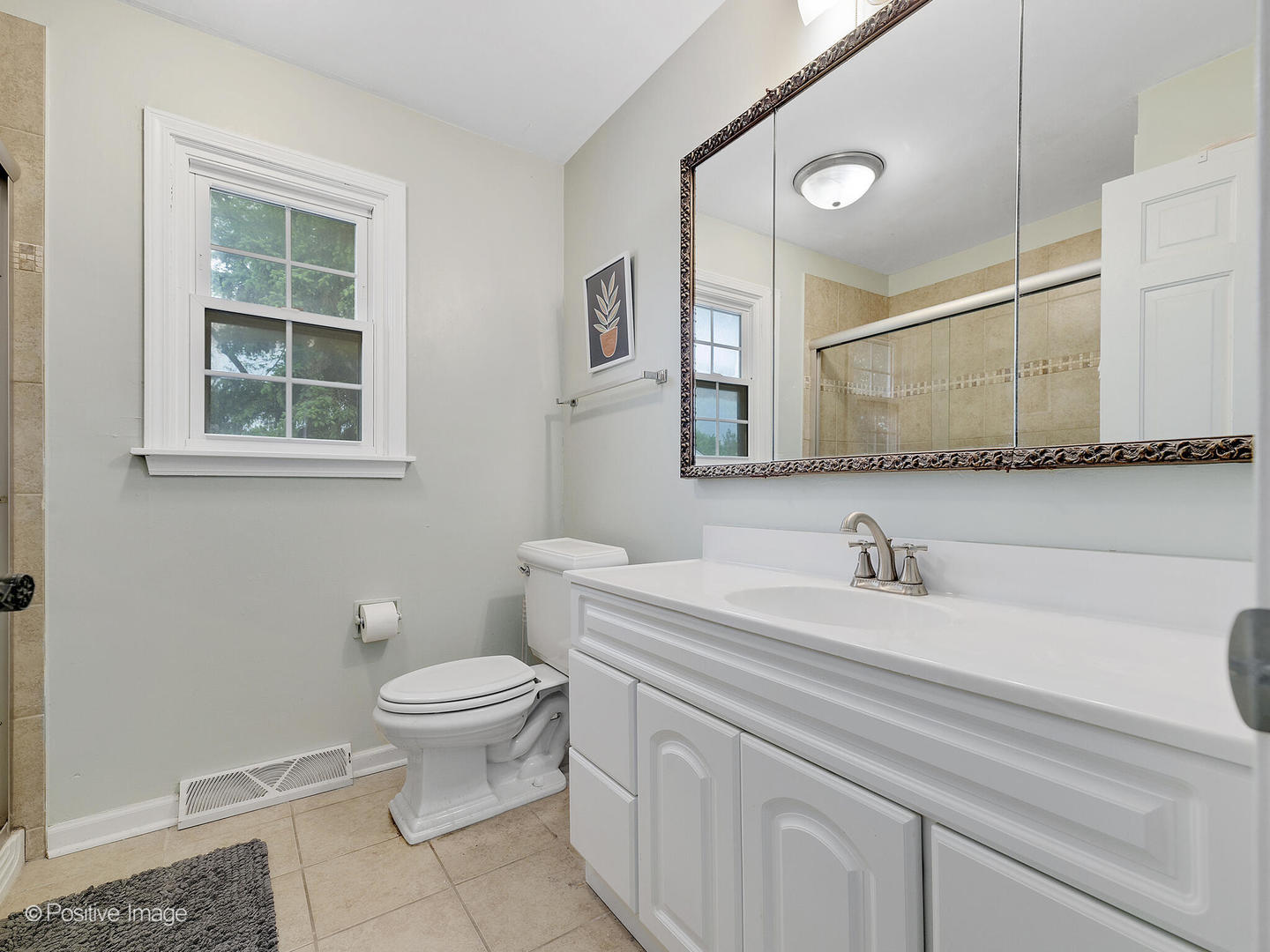 800 West Roosevelt Road Wheaton, IL 60187 - Photo 18 of 28 a bathroom with a toilet sink and mirror
