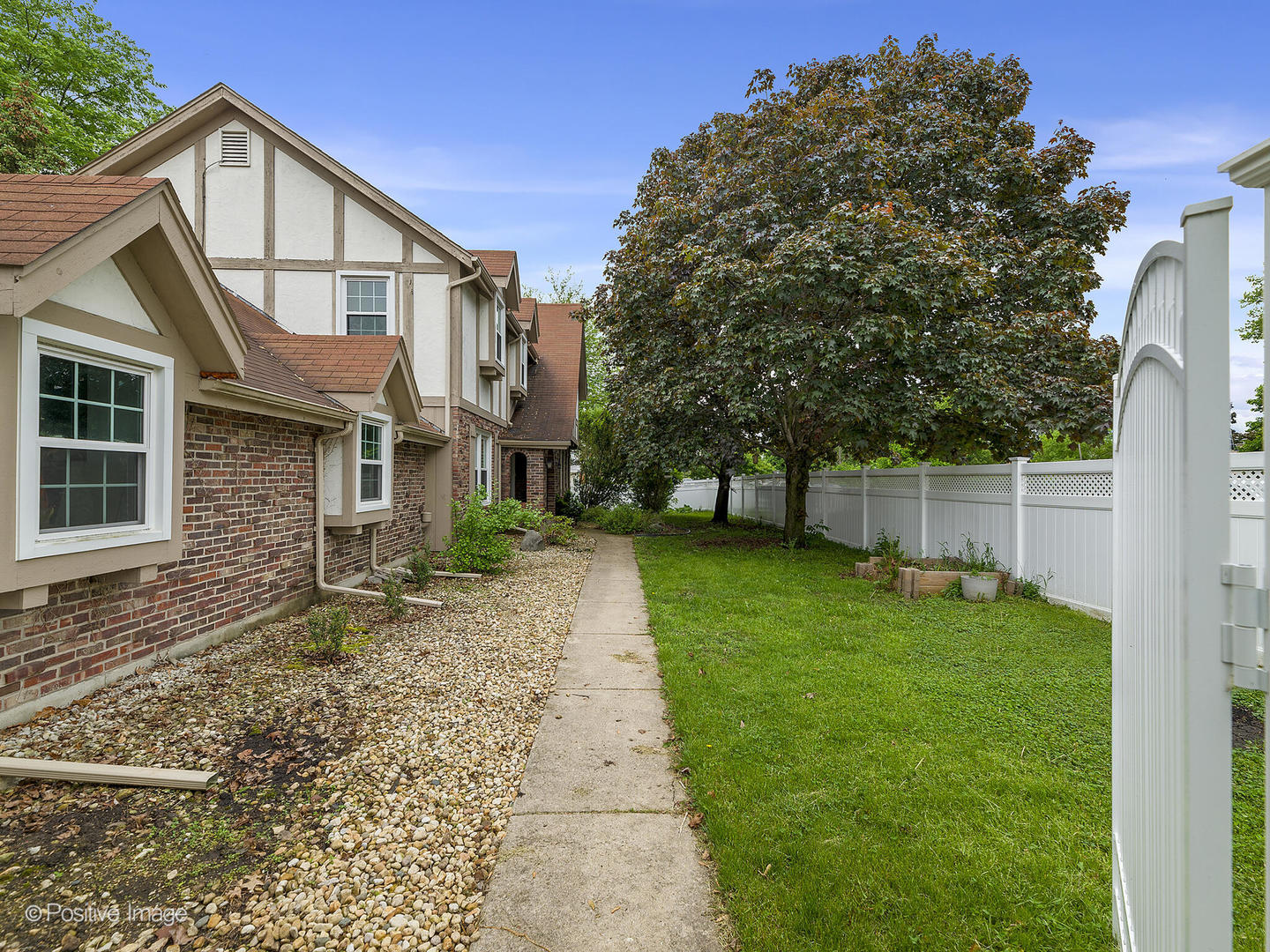 800 West Roosevelt Road Wheaton, IL 60187 - Photo 2 of 28 a view of a brick house with a yard
