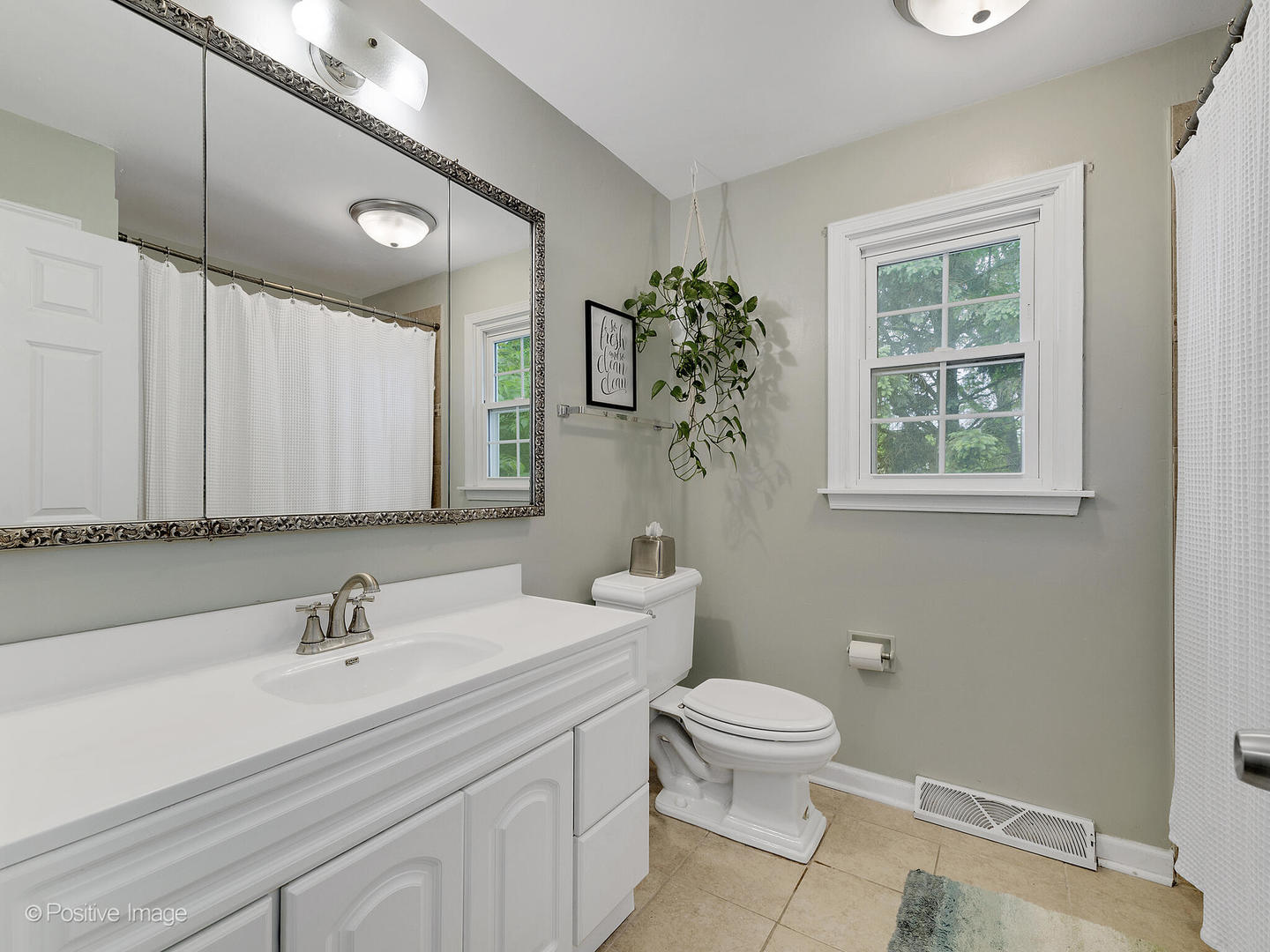 800 West Roosevelt Road Wheaton, IL 60187 - Photo 22 of 28 a bathroom with a sink a toilet and a mirror