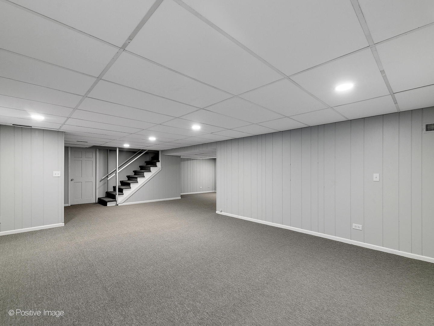 800 West Roosevelt Road Wheaton, IL 60187 - Photo 25 of 28 an empty room with a ceiling fan and stairs