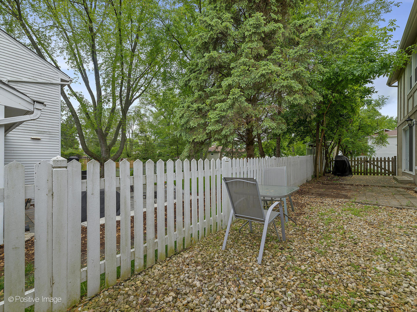 800 West Roosevelt Road Wheaton, IL 60187 - Photo 26 of 28 a wooden fence with trees in the background
