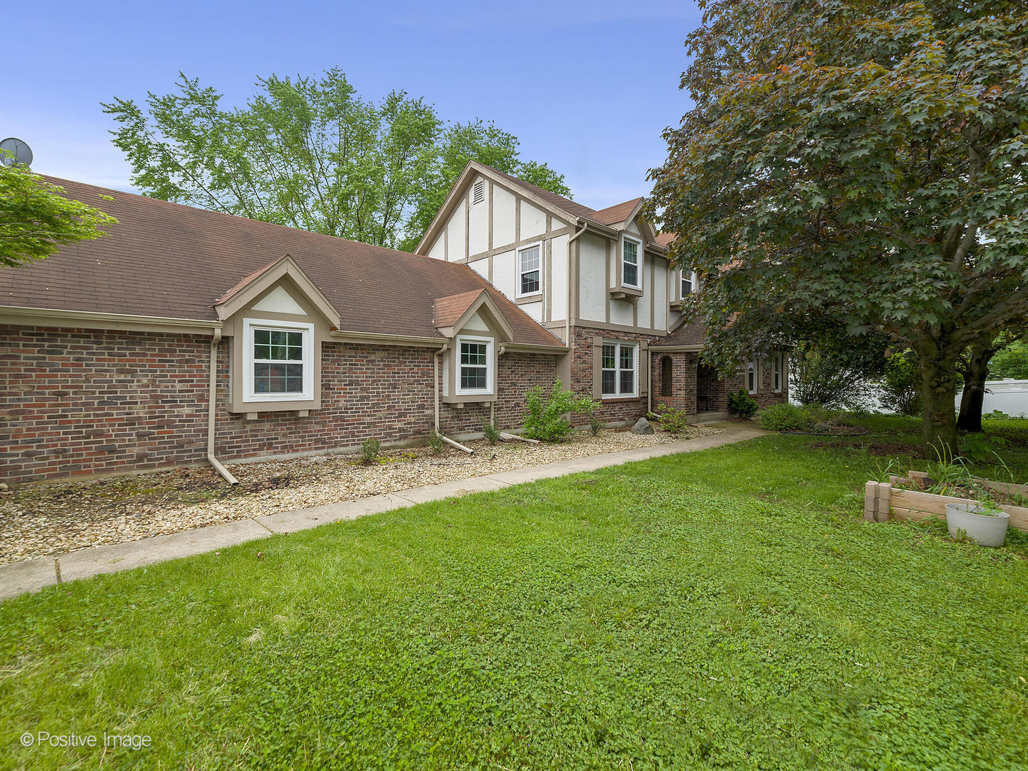 800 West Roosevelt Road Wheaton, IL 60187 - Photo 3 of 28 a view of a yard in front of a house with large tree
