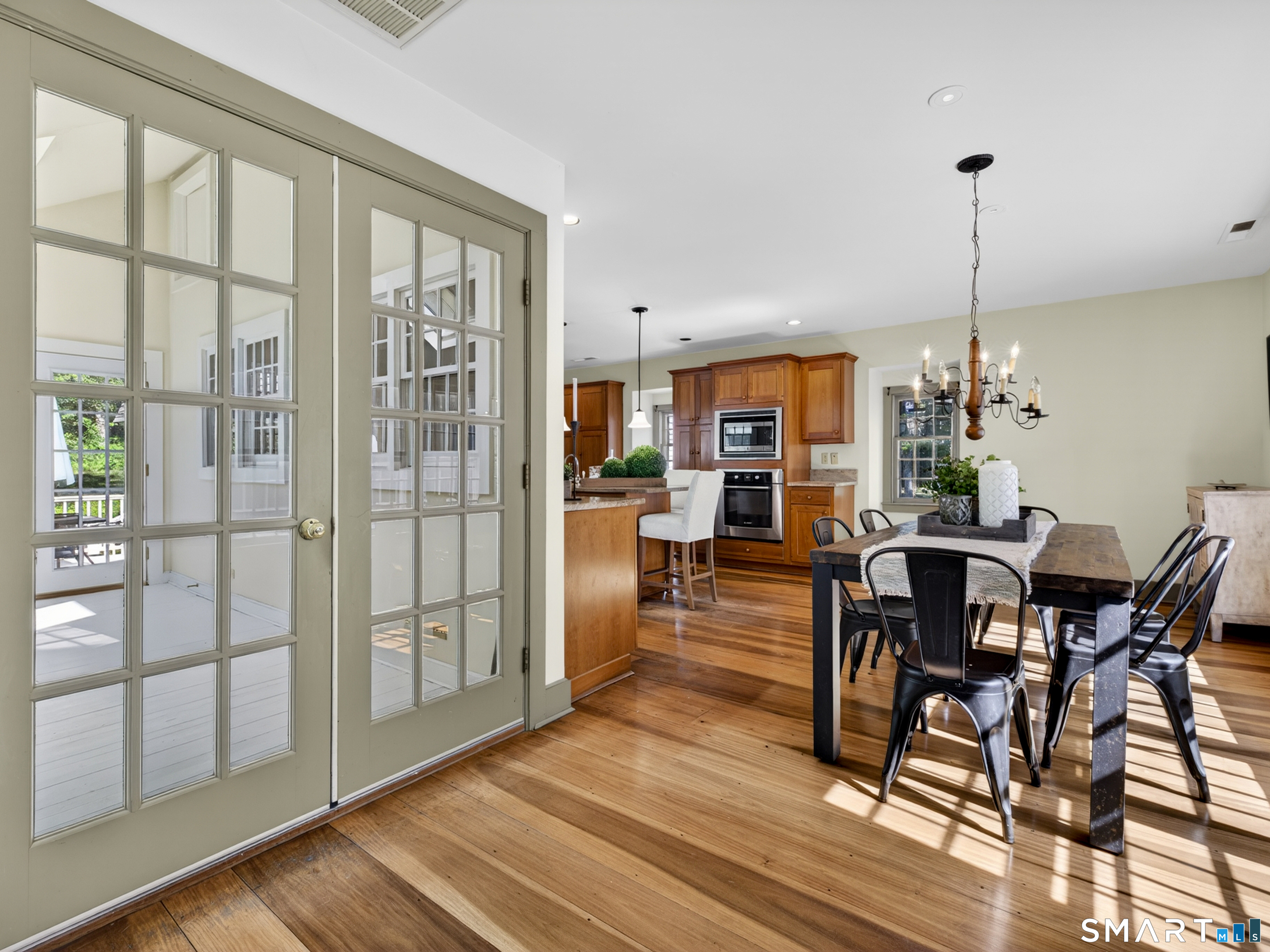 14 Cow Pen Hill Road Killingworth, CT 06419 - Photo 24 of 40 French doors lead from the updated eat-in kitchen to a light-filled sun porch, offering the perfect transition to the patio and backyard for indoor-outdoor living.