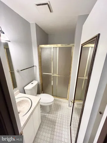 a white toilet sitting next to a tub