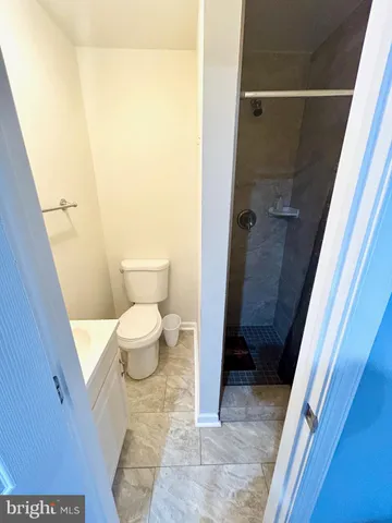 a bathroom with a toilet and a shower