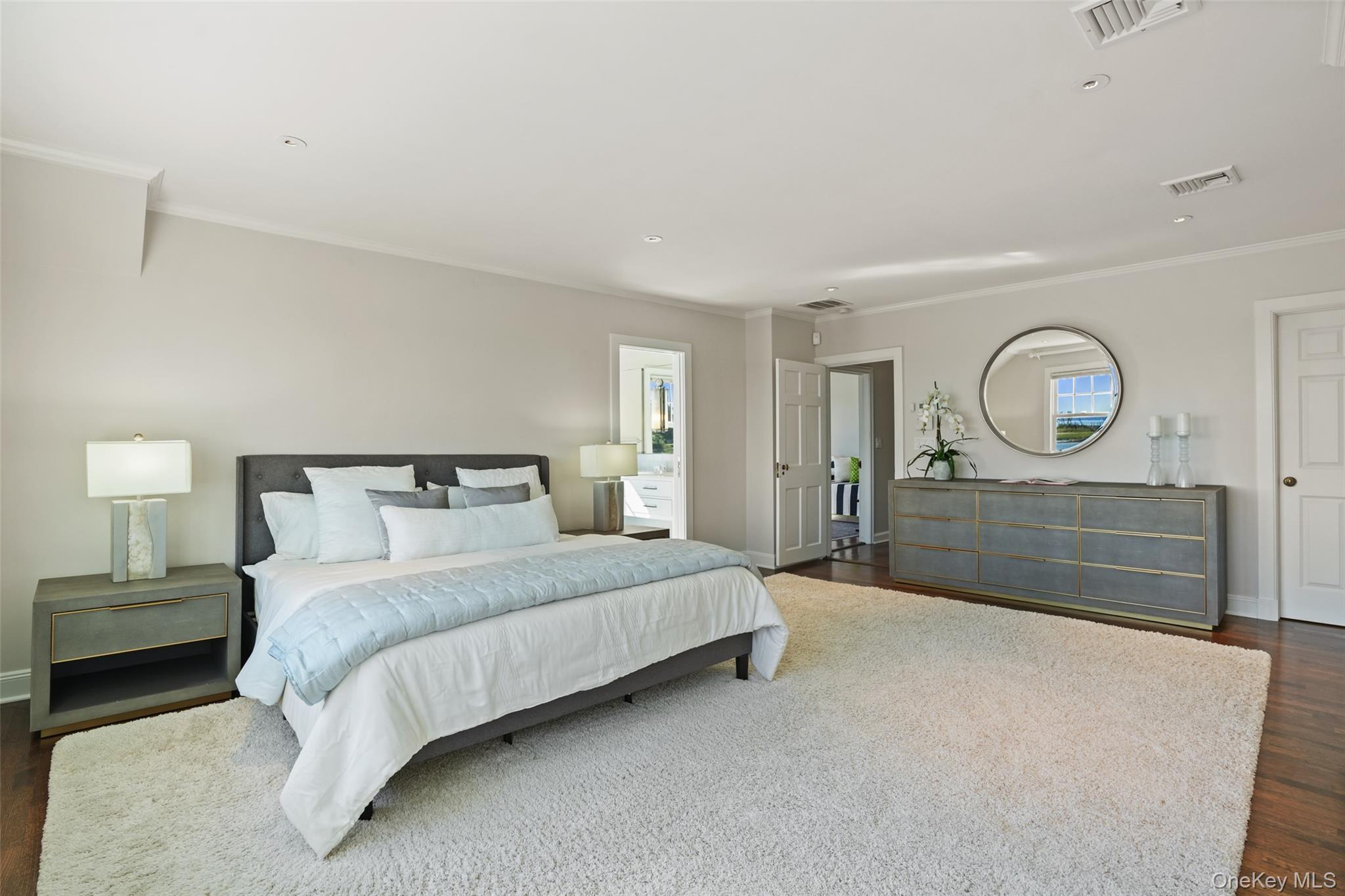 6 Pine Island Road Rye, NY 10580 - Photo 19 of 38 a bedroom with a bed a mirror and a dresser