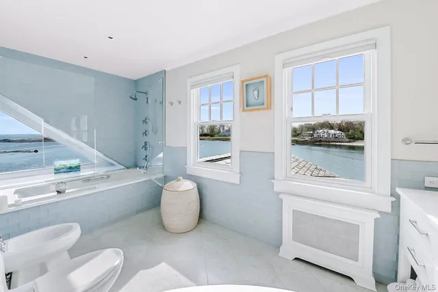 a front view of a house with garden yard and sitting area