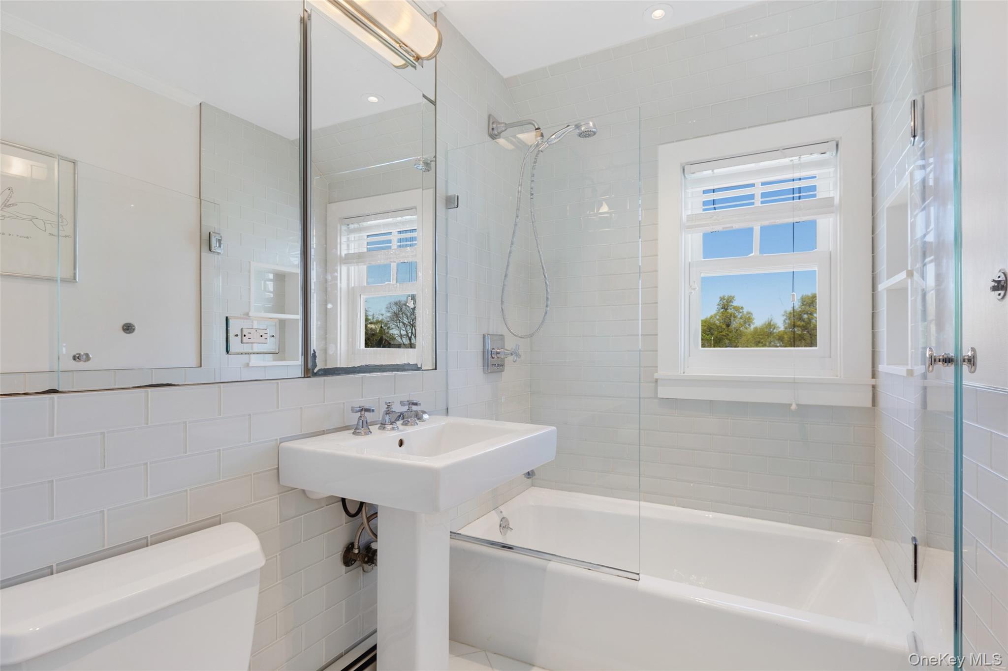 6 Pine Island Road Rye, NY 10580 - Photo 29 of 38 a bathroom with a sink a toilet and a bathtub