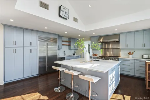 a living room with furniture a wooden floor and a large window