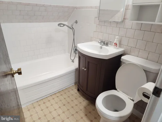a bathroom with a sink a toilet and bathtub