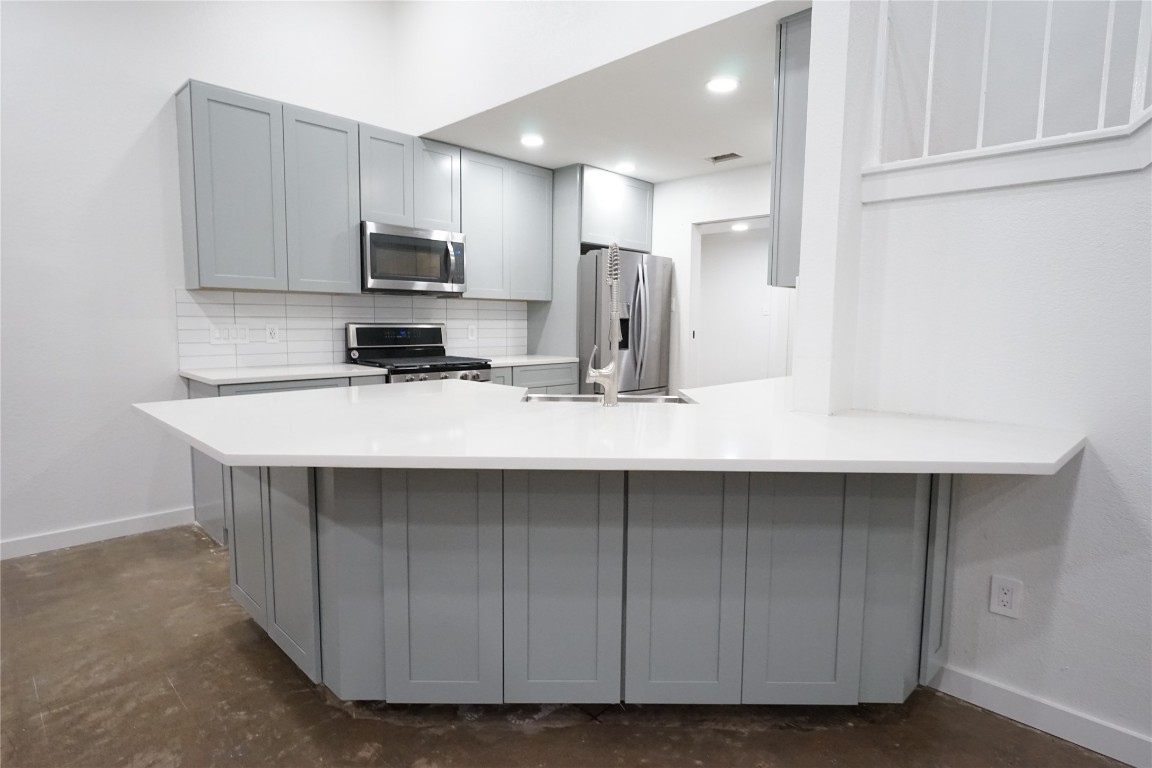 8006 Tiffany Drive Austin, TX 78749 - Photo 14 of 22 a kitchen with stainless steel appliances a sink a microwave a refrigerator and white cabinets