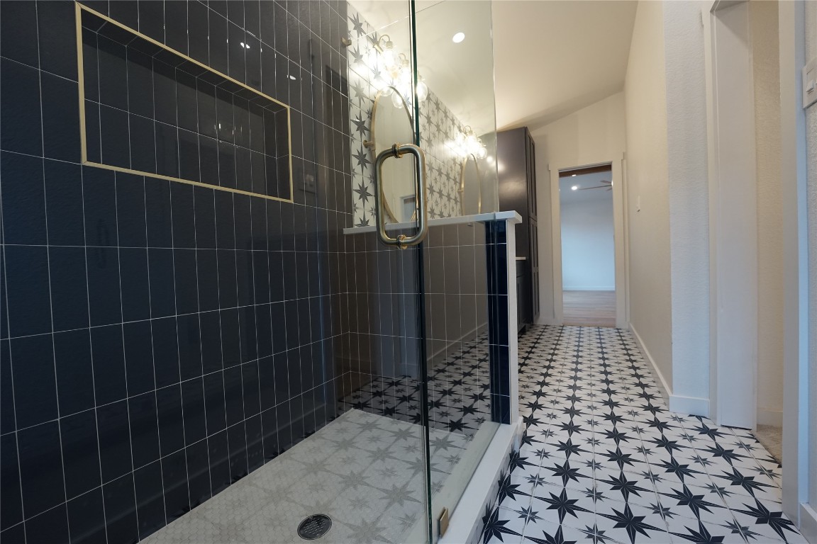 8006 Tiffany Drive Austin, TX 78749 - Photo 8 of 22 a bathroom with a glass shower door