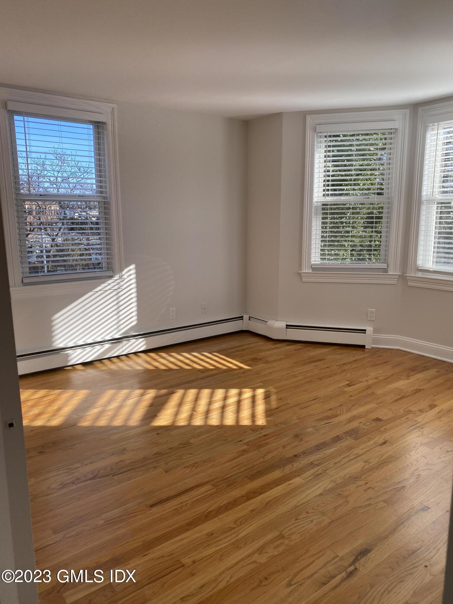 11 Old Field Point Road, Unit 2A Greenwich, CT 06830 - Photo 9 of 12 a view of a room with wooden floor and a window