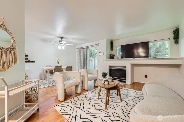 a living room with furniture a fireplace and a flat screen tv