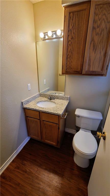 1907 Robbins Place, Unit 201 Austin, TX 78705 - Photo 4 of 5 Half bath featuring vanity and dark wood-style floors