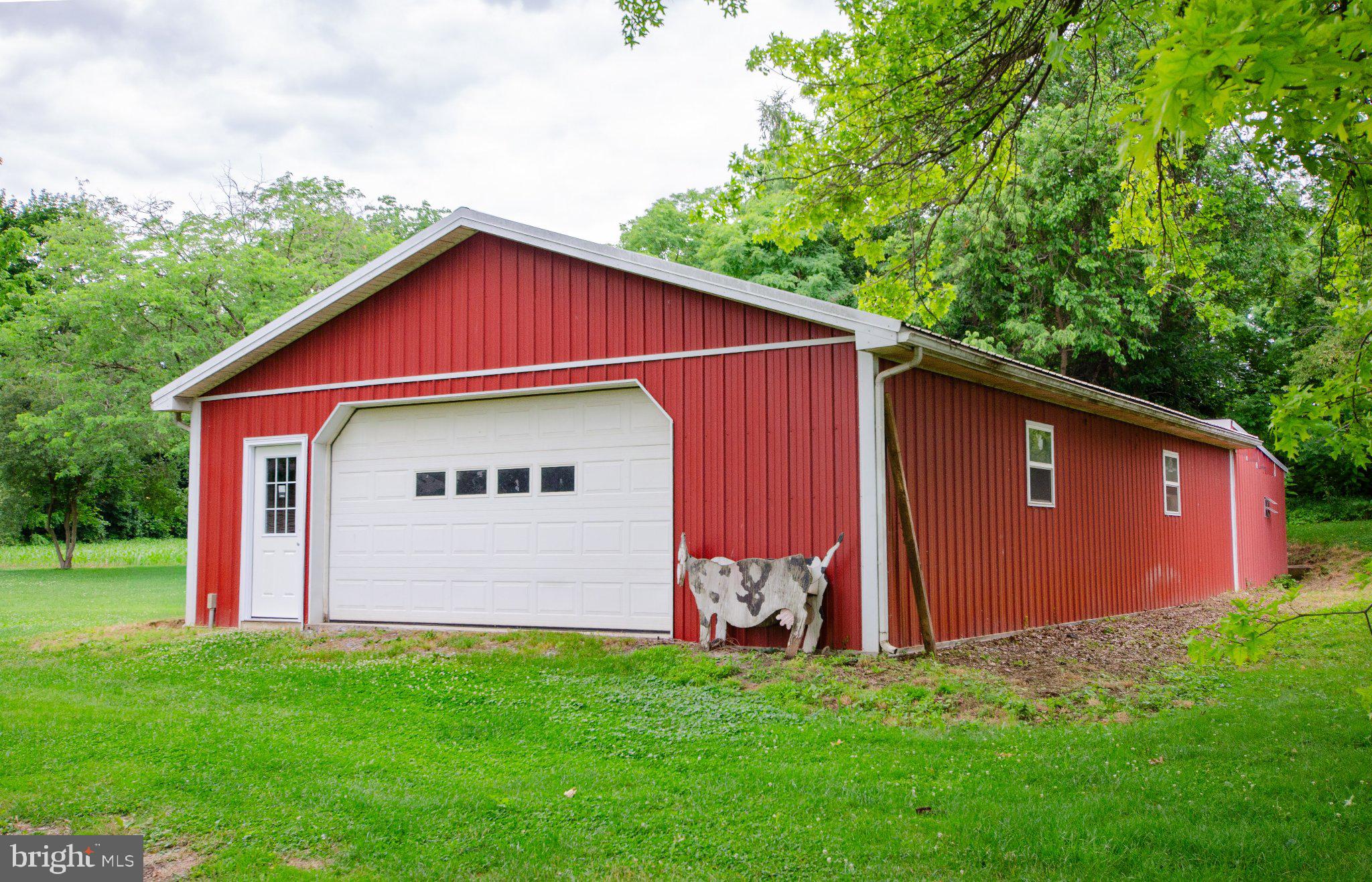 2615 Walnut Bottom Road Carlisle, PA 17015 - Photo 36 of 38 Charming red barn in lush greenery.