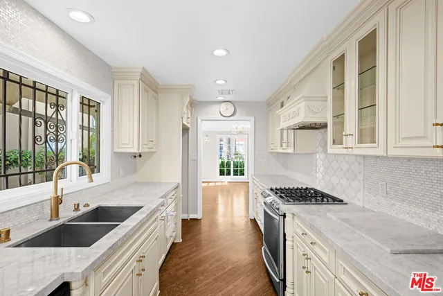 a kitchen with granite countertop a stove and a sink