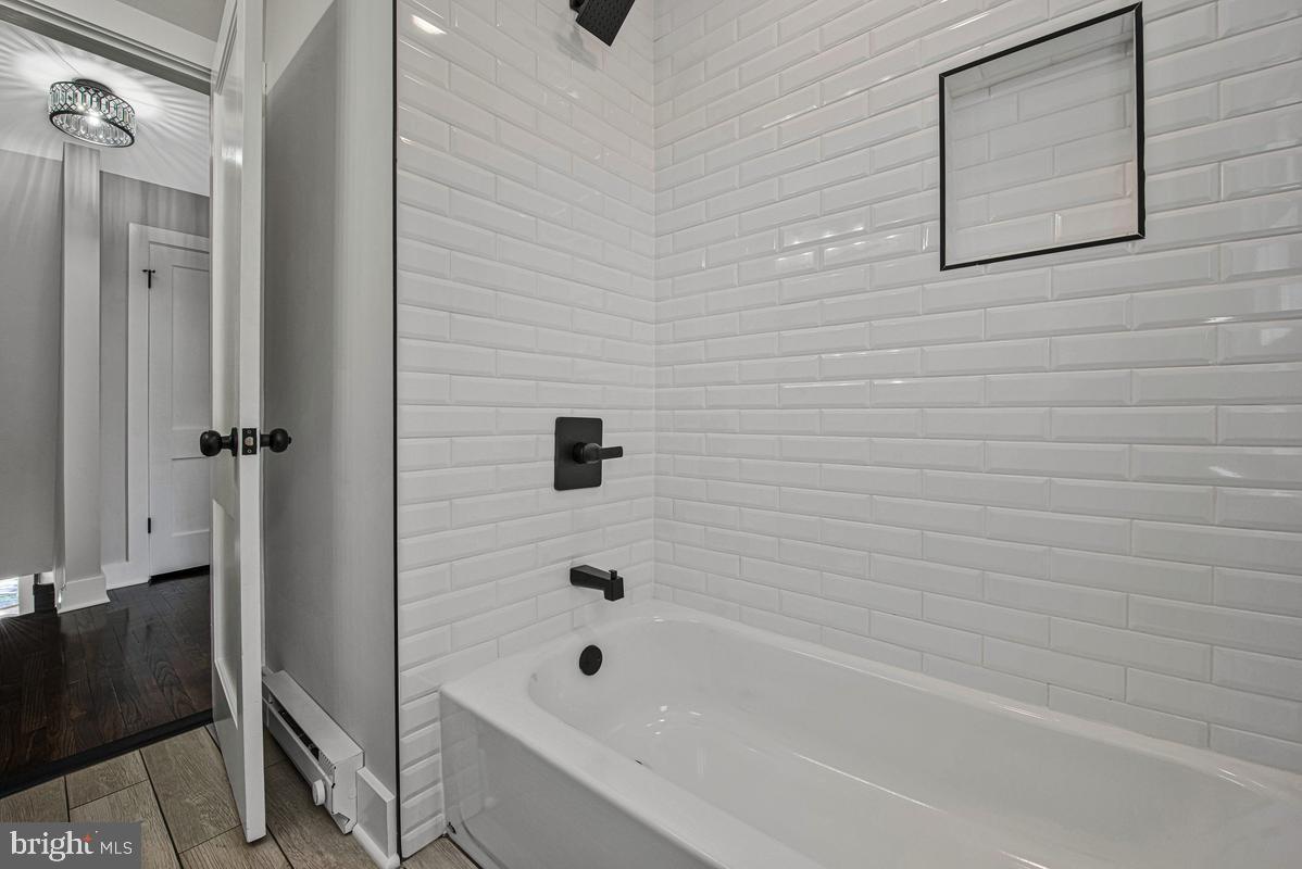 2105 Queens Chapel Road Mount Rainier, MD 20712 - Photo 17 of 33 a bathroom with a bathtub