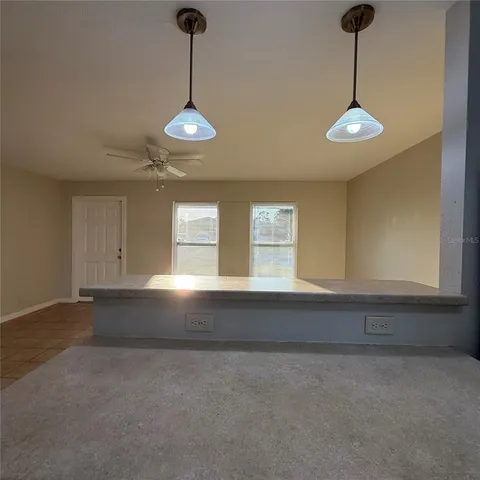 a view of a room with windows and cabinet