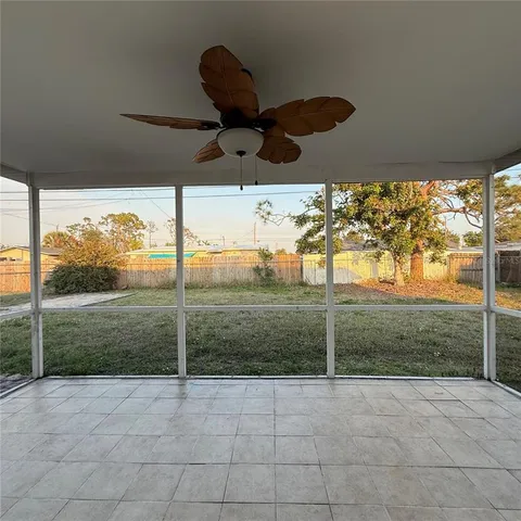 a view of a room with porch and couches chairs