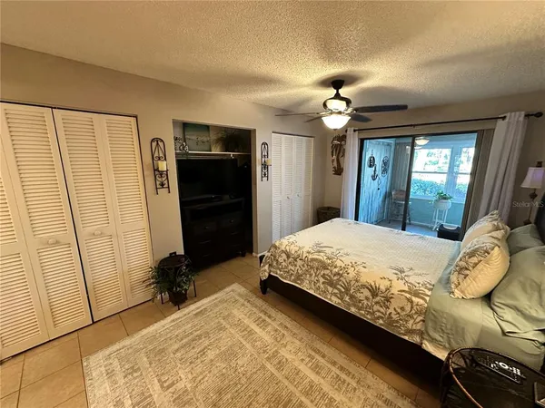 a bedroom with a bed dresser and a window
