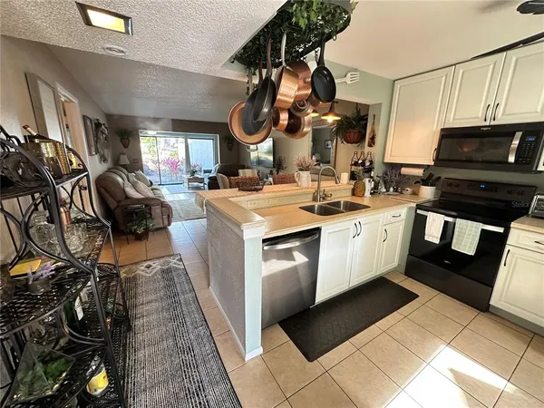 a kitchen with a sink cabinets and appliances
