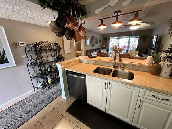 a kitchen that has a lot of cabinets and wooden floor