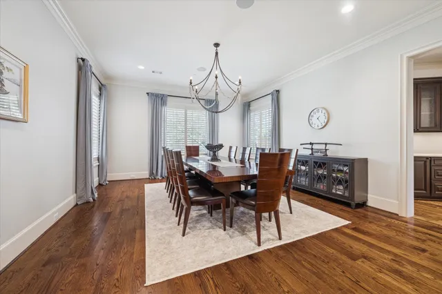 a spacious bedroom with a bed a chandelier and a window