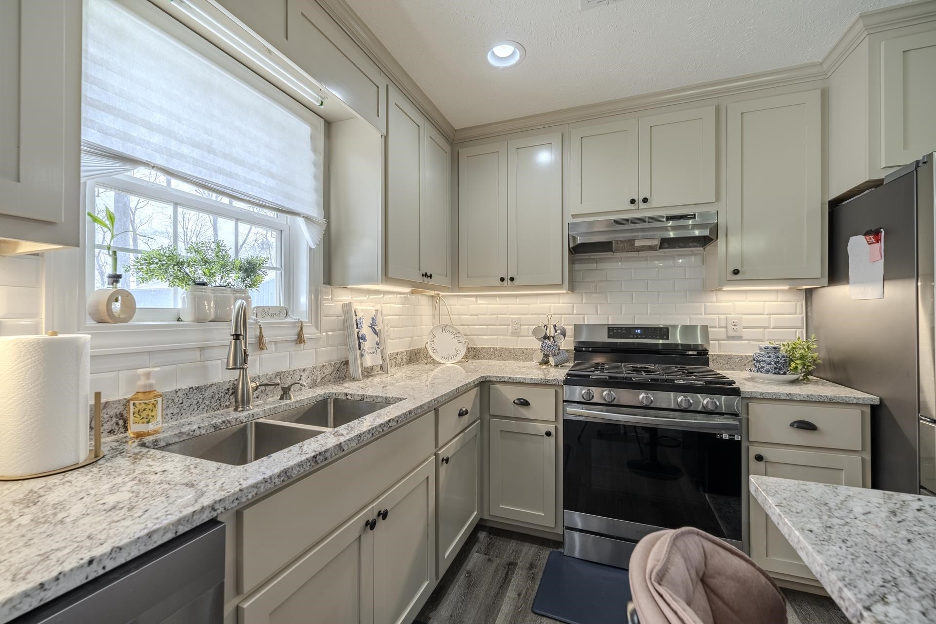50 Perry Place Savannah, TN 38372 - Photo 11 of 38 a kitchen with a sink stove top oven and cabinets