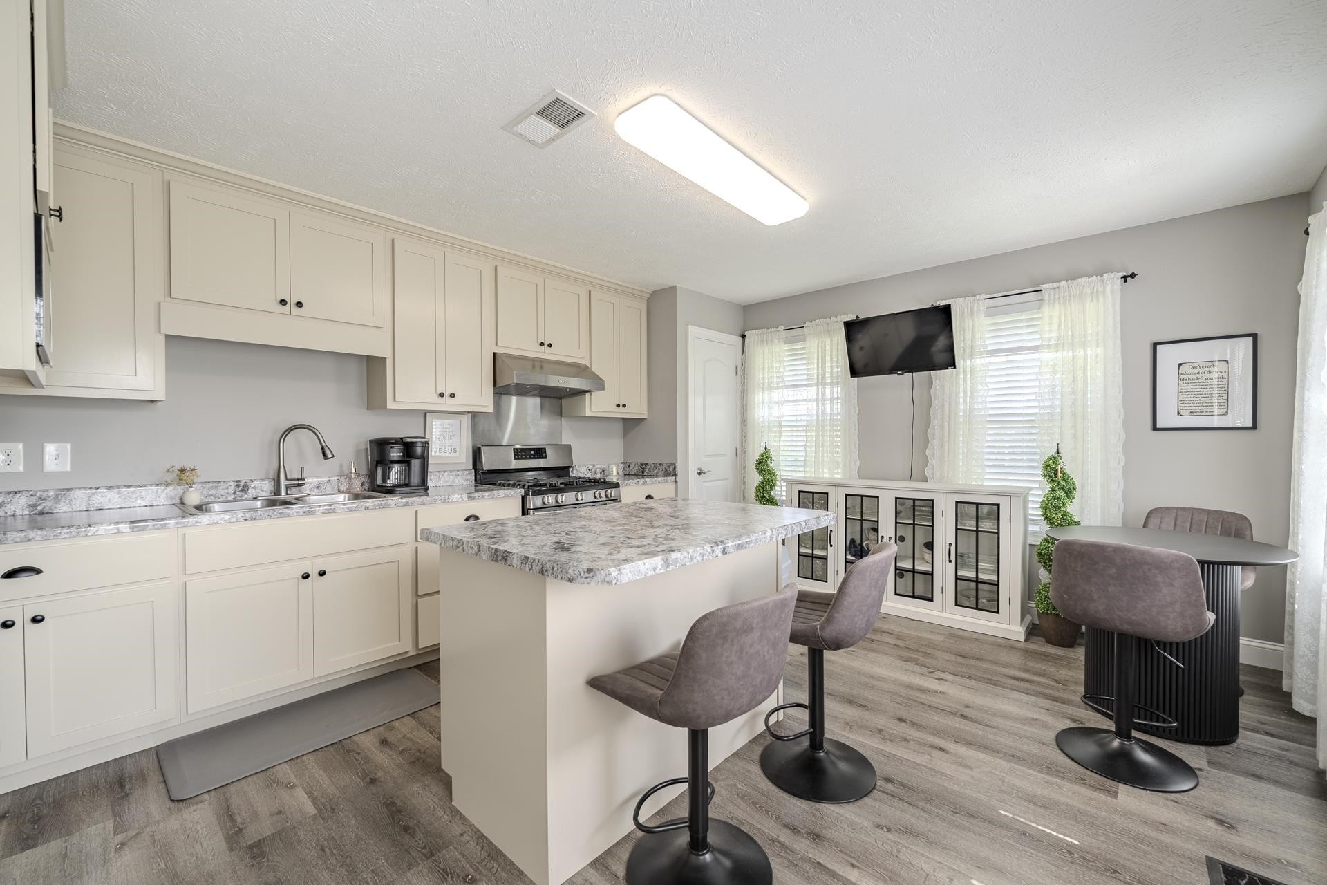 50 Perry Place Savannah, TN 38372 - Photo 8 of 38 a kitchen with cabinets a sink and chairs in it
