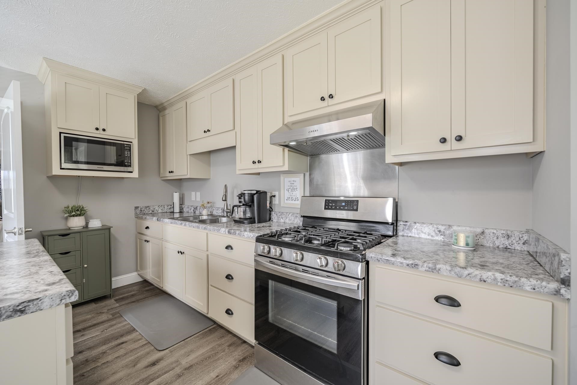 50 Perry Place Savannah, TN 38372 - Photo 9 of 38 a kitchen with granite countertop white cabinets and stainless steel appliances