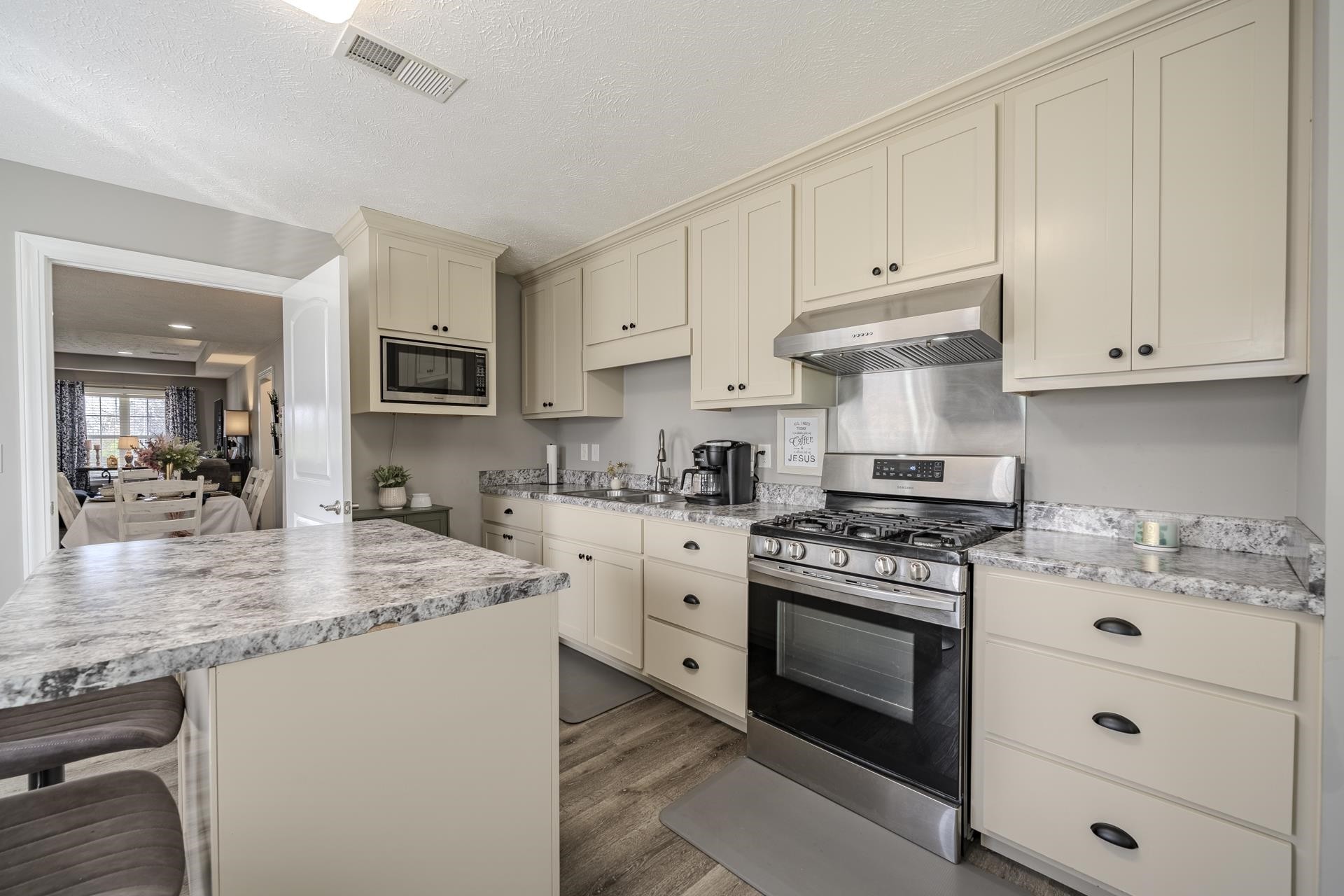 50 Perry Place Savannah, TN 38372 - Photo 10 of 38 a kitchen with granite countertop a stove sink and cabinets