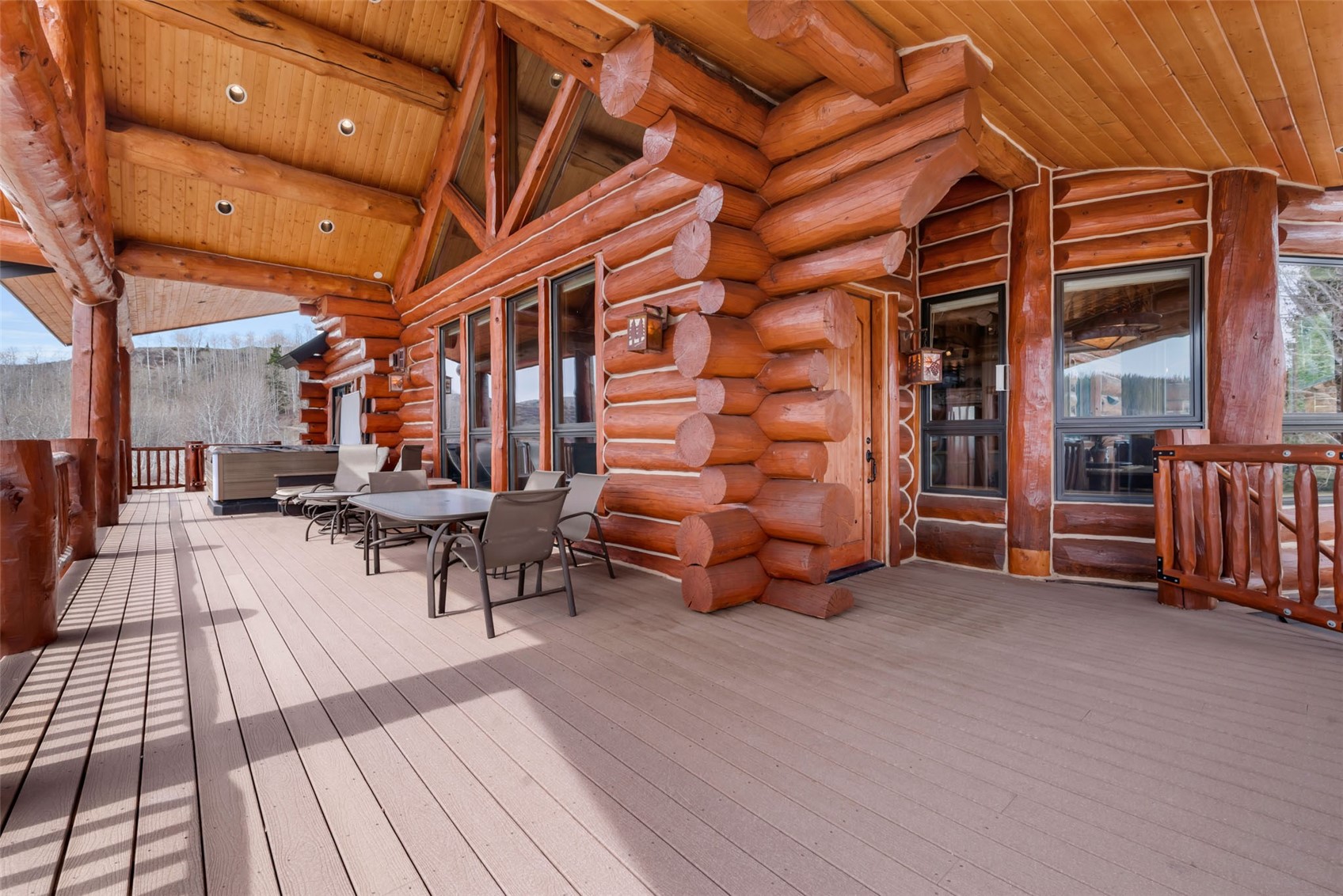 26755 Little Hawk Lane Clark, CO 80428 - Photo 14 of 47 a view of a patio with table and chairs with wooden floor and fence