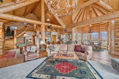 a dining room with wooden floor a chandelier