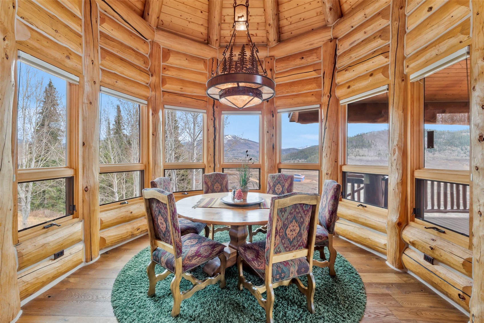 26755 Little Hawk Lane Clark, CO 80428 - Photo 19 of 47 a dining room with wooden floor a chandelier
