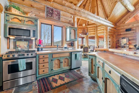 a kitchen with stainless steel appliances granite countertop a stove and a microwave