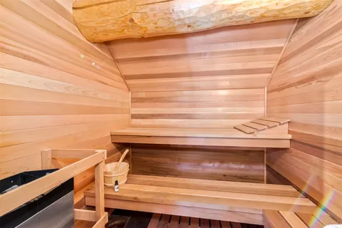 a bathroom with a tub a sink and a mirror