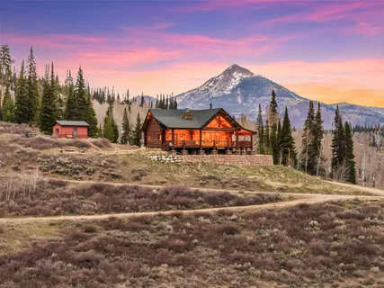 a view of a house with a snow in the background