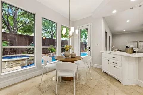 a living room with furniture and large windows