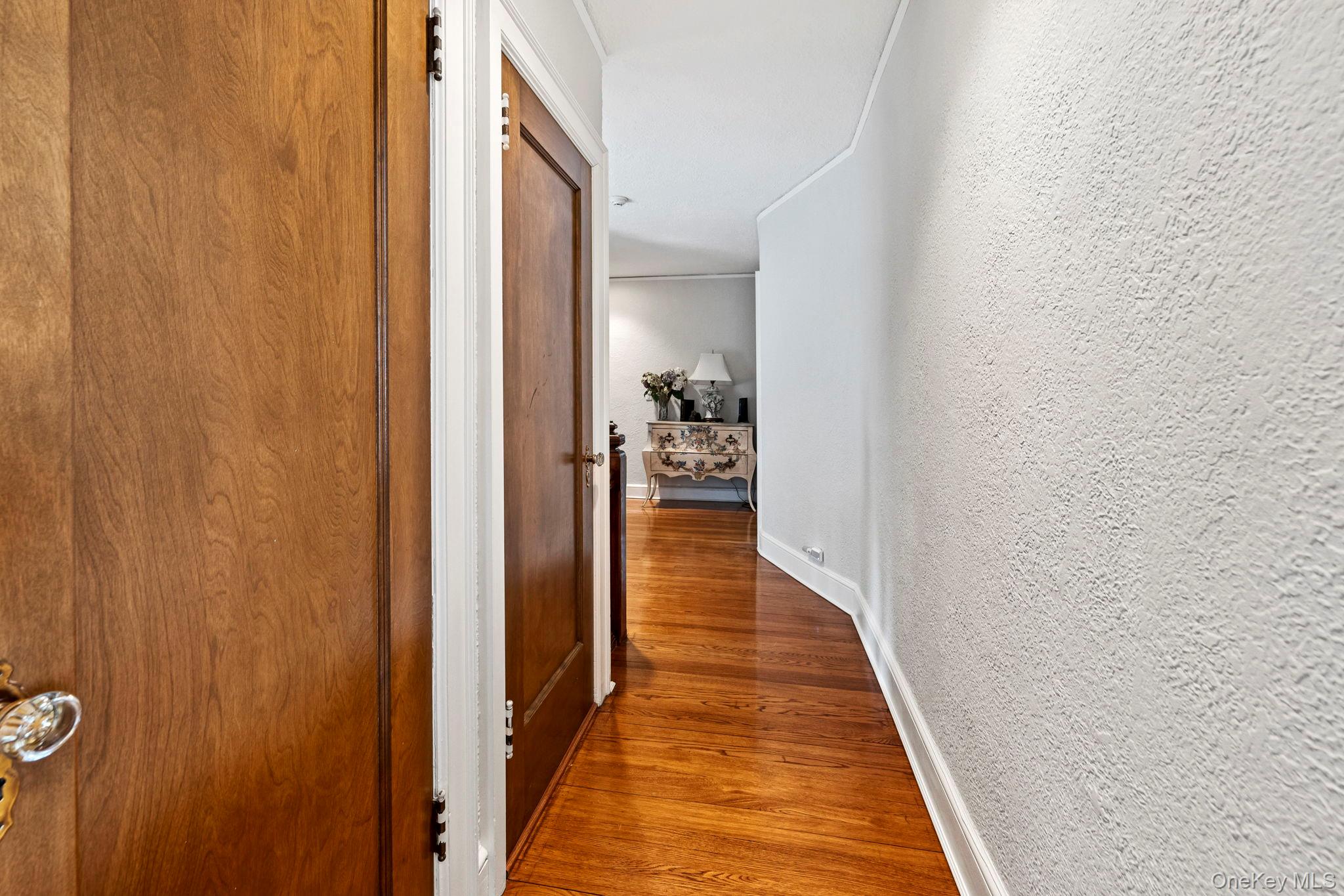 44 Fenimore Road New Rochelle, NY 10804 - Photo 25 of 46 a view of a hallway with wooden floor and a bathroom