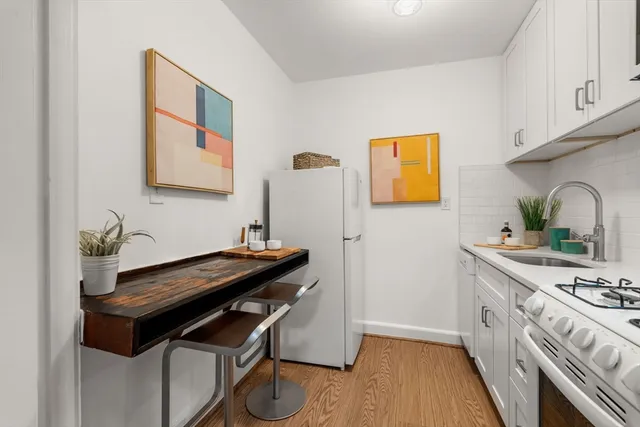 a kitchen with a stove and a refrigerator