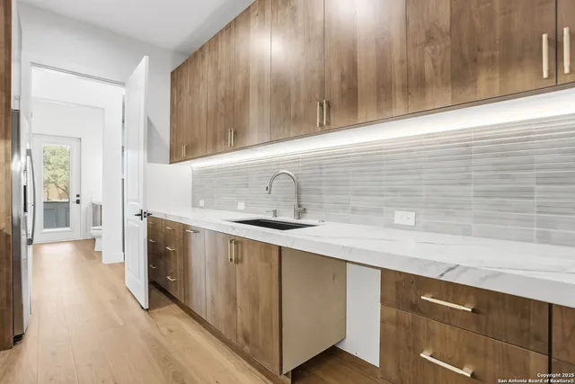 a kitchen with stainless steel appliances a sink stove and cabinets