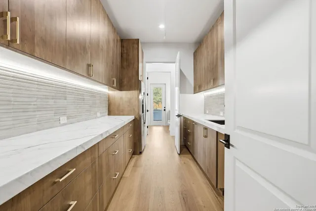 a kitchen with a sink stove and refrigerator